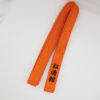 orangener Karate Gürtel bestickt in schwarz mit Shotokan